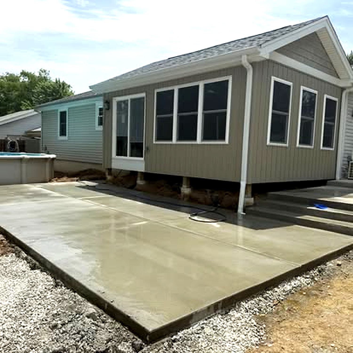 Decorative concrete patio finish next to pool by True Form Concrete